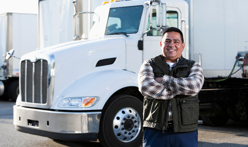 Man Standing in Front of Truck Smiling